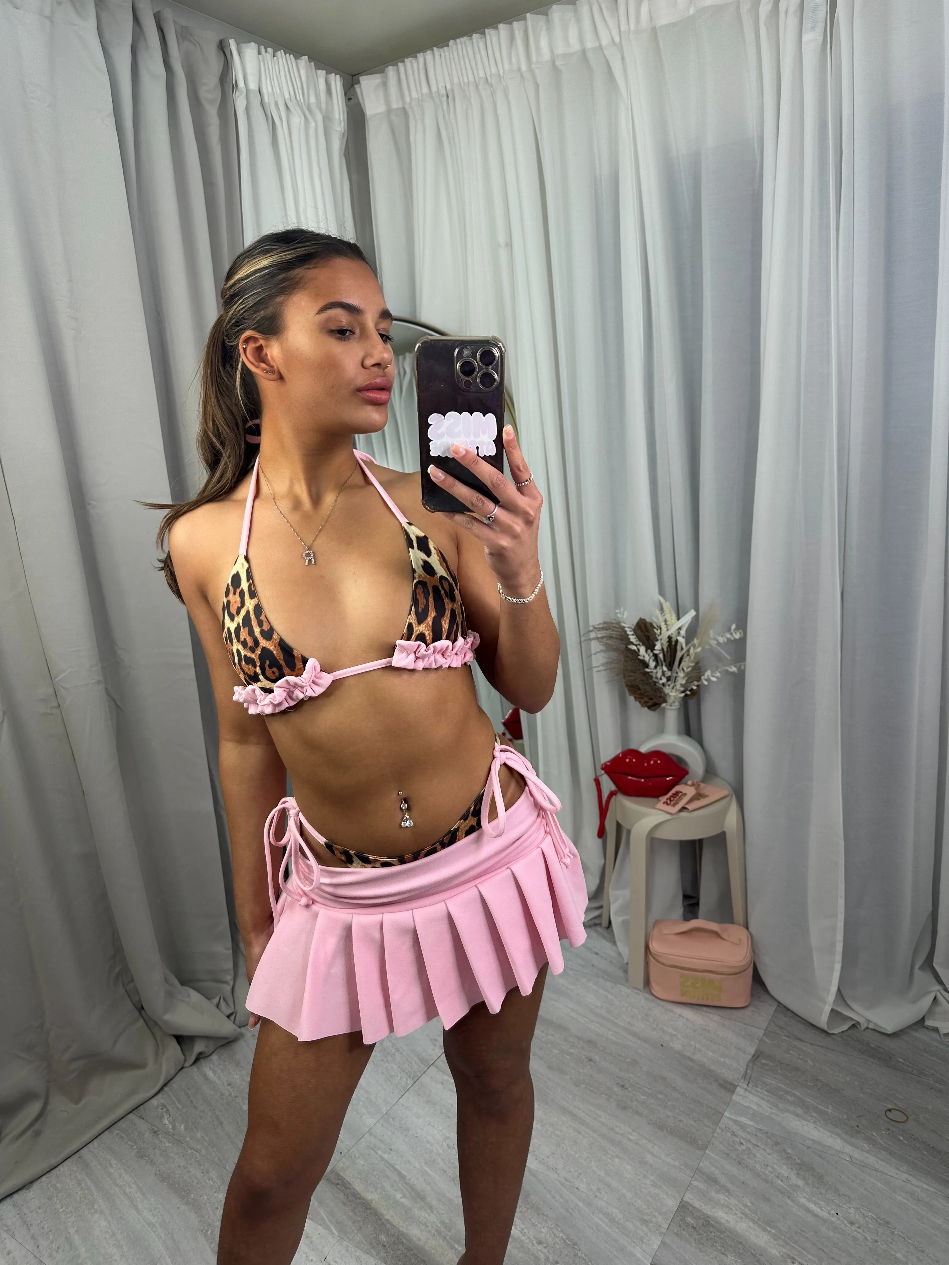 Summer pleated mini skirt with bikini bottoms and top outfit